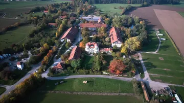 Aerial view of a rural estate with buildings.
