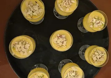 Glasses of yellow dessert on a tray