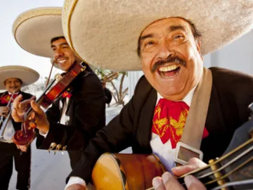 Musicians happily play music in traditional clothes.