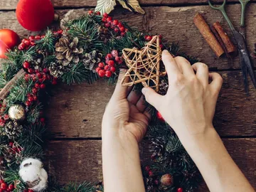 Wrinkle your hands and place a star on an advent wreath, rustic.