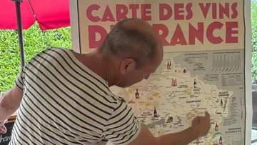 Man pointing at French wine map.