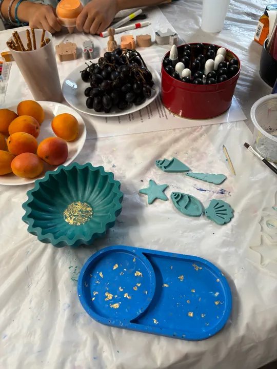 Crafting materials and fruit on a table.