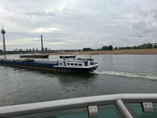 Cargo ship sailing on a wide river.