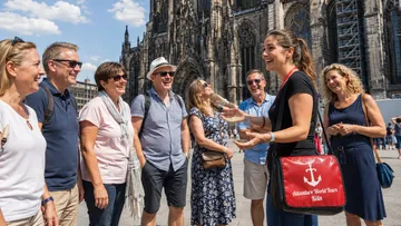 Group tourists listening guide outside cathedral.