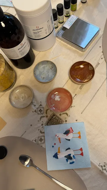 Table with oils, bowls, and napkin.