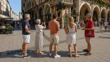 Touristen hören einem Führer auf historischem Platz zu.