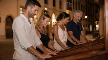 People playing music on large wooden instruments outdoors.