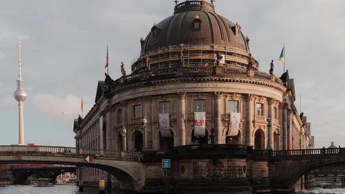 Dome-topped museum with surrounding river and towers.