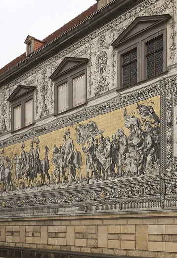 Mural depicting historical figures on building facade.