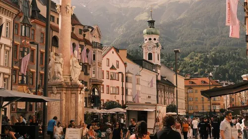 People walking in a European city square.