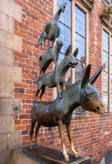 Animal statue stacking outside building.