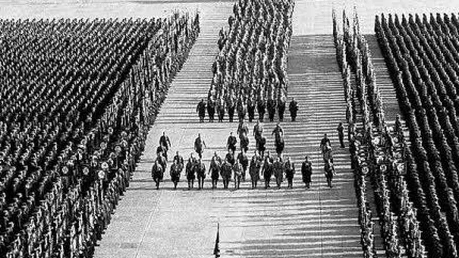 Soldiers march in massive formation outdoors.