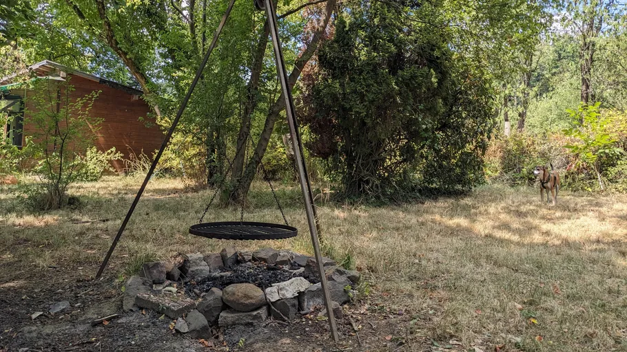 Empty grill over fire pit in backyard.