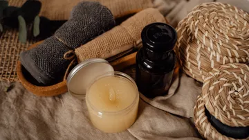 Candles and towels on a textured surface.