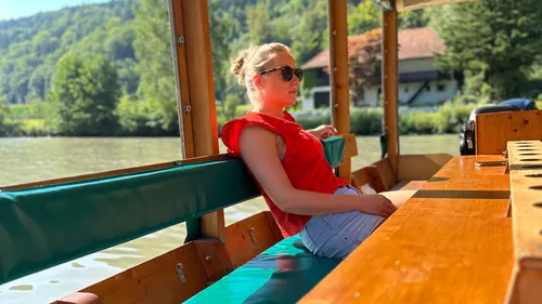 Woman relaxing on a boat in nature.