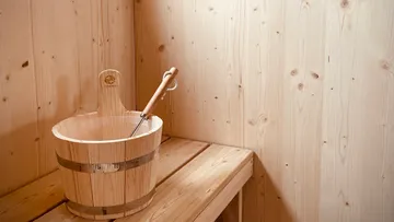 Wooden bucket on a sauna bench.