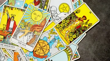 Tarot cards scattered on a table.