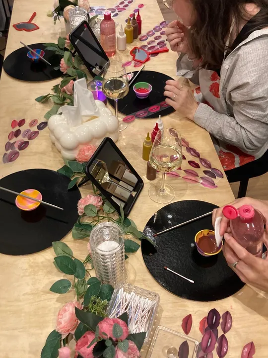 People crafting lip-shaped decorations indoors.