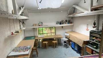 Art studio with tables and supplies.