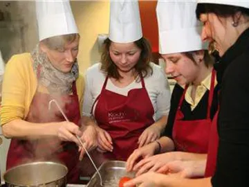 Cooking with several people in a kitchen setting.