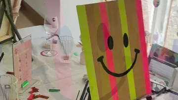 Colorful painting of smiley face on table.