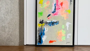 Abstract painting leaning against wall.