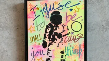 Astronaut silhouette with colorful motivational text.