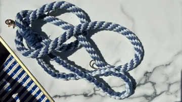 Blue rope coiled on a marble surface.