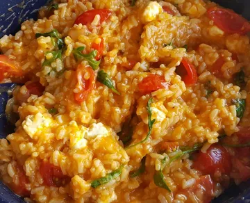 Risotto mixed with cherry tomatoes and greens.