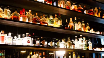 Liquor bottles displayed on bar shelves.