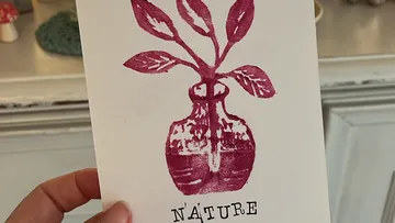 Card with red plant print and text