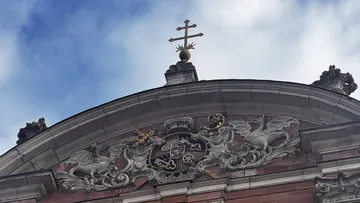 Intricate architectural crest on building facade.