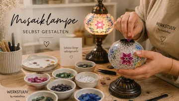 Person gestaltet Mosaiklampe auf Tisch.