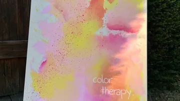 Colorful abstract painting leaning against a wall.