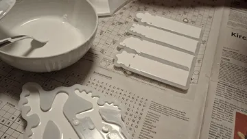 Plaster crafting materials on newspaper table.