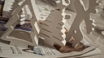White tree figurines on a magazine.