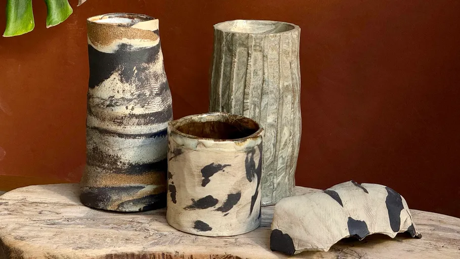 Ceramic vases on wooden table, indoors.