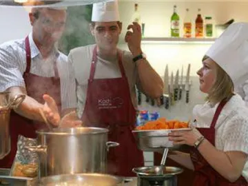 Chefs prepare food in a modern kitchen.