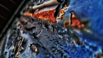Close-up of rusty, peeling metal surface.
