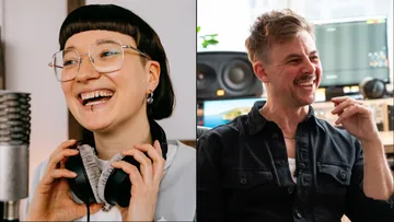 Two people laughing in a recording studio.
