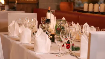 Elegant table set with wine glasses and napkins.