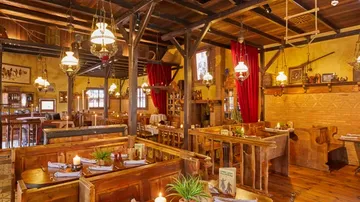 Cozy restaurant interior with wooden tables.