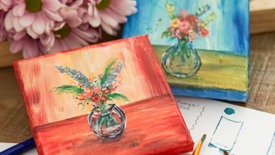 Paintings of flowers in vases on table.