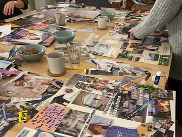 Tisch mit Zeitschriften, Personen erstellen ein Moodboard.