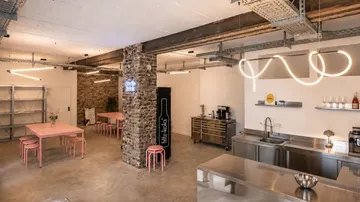 Industrial kitchen with tables and seating.