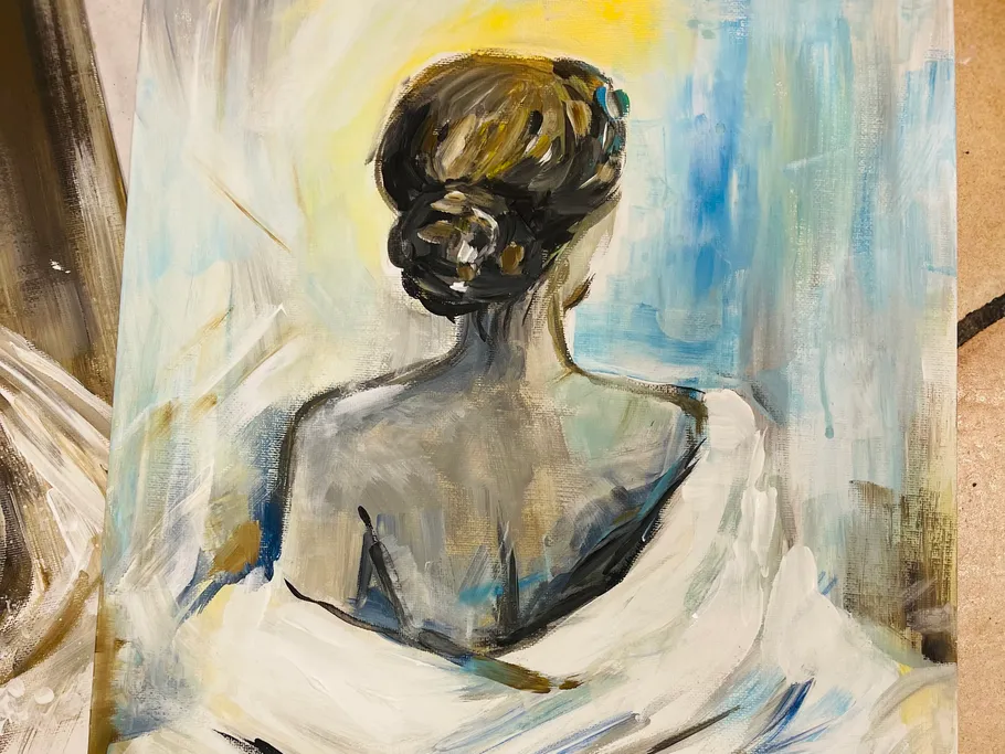 A woman with her hair up looks backwards.