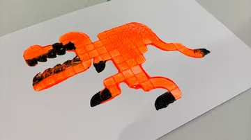 Orange Dinosaurierzeichnung auf weißem Papier.