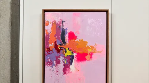 Abstract painting with vibrant colors on wall.