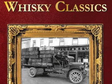 An old truck is transporting whiskey cases in a city.
