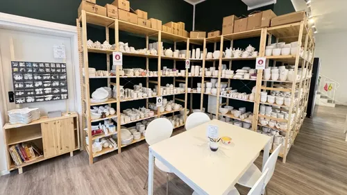 Shelves with pottery in craft studio.